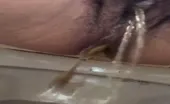 Hairy ebony shitting in toilet