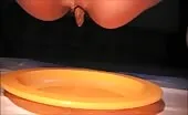 Cute girl shitting on yellow plate