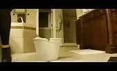 She's pooping in a red bucket